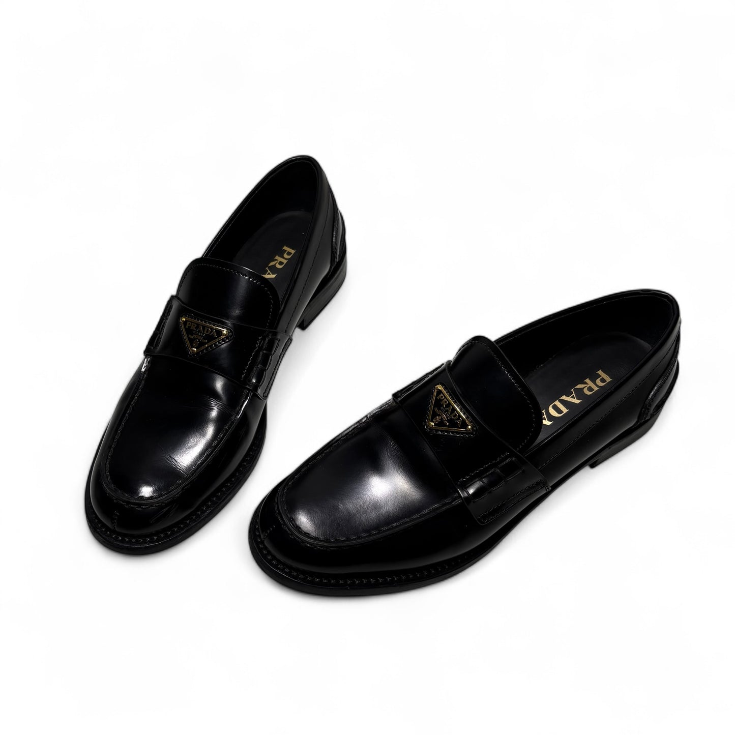 Prada mocassini in pelle spazzolata nera e loghi in oro 37,5